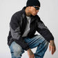 sitting view of side zip pockets and adjustable hem cinch cord on dark grey black Y2K jacket
