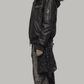 Side profile view displaying the slouchy, comfortable baggy Y2K fit of a men's black leather bomber coat with soft fur lining.