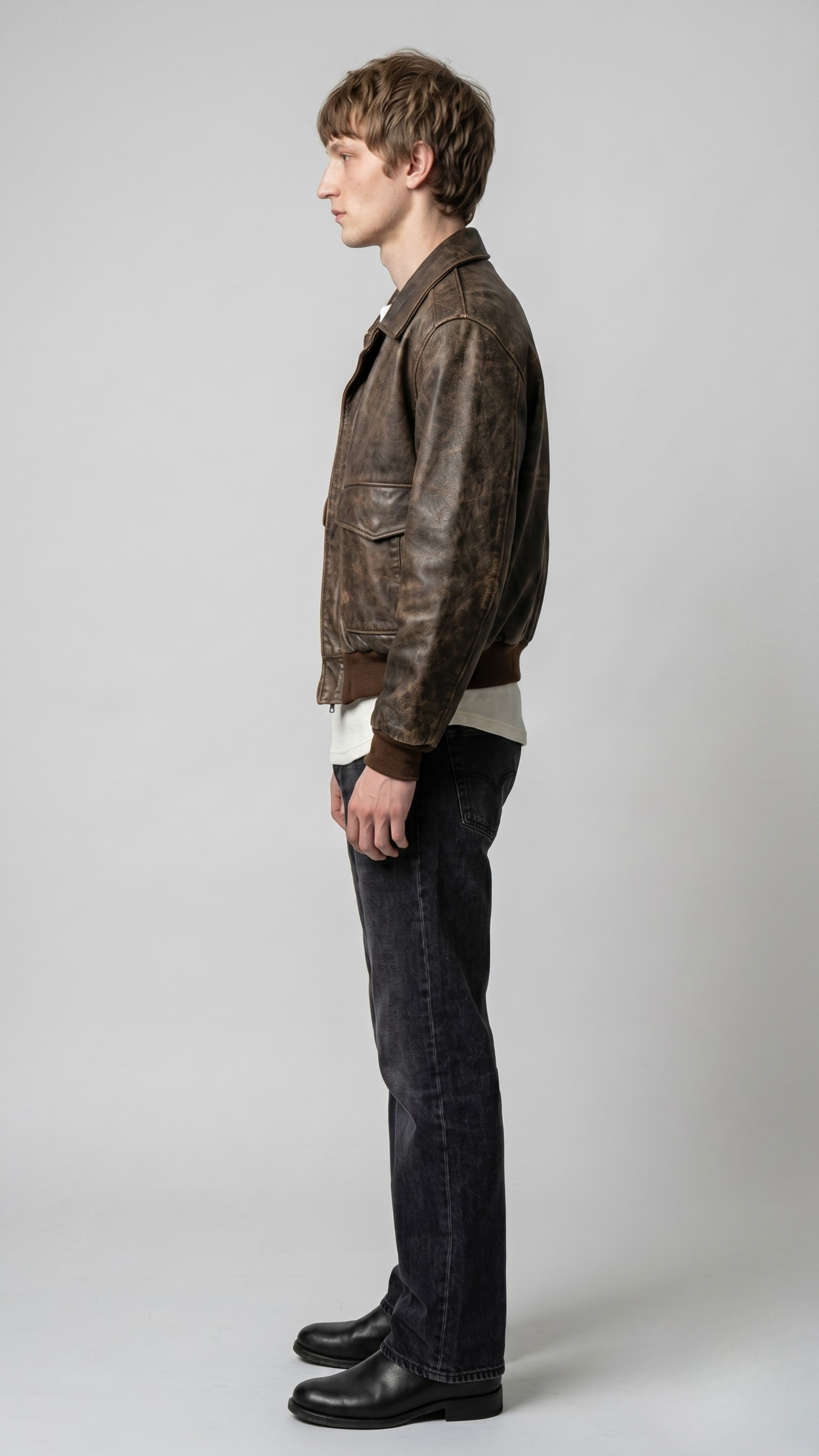 Side angle profile view highlighting the heavy-duty antique brass zippers and premium elastic rib-knit cuffs of the vintage brown outerwear.