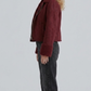 Side angle profile shot showcasing the heavy-duty metallic zippers, pockets, and adjustable waist buckles of the premium maroon suede aviator outerwear.