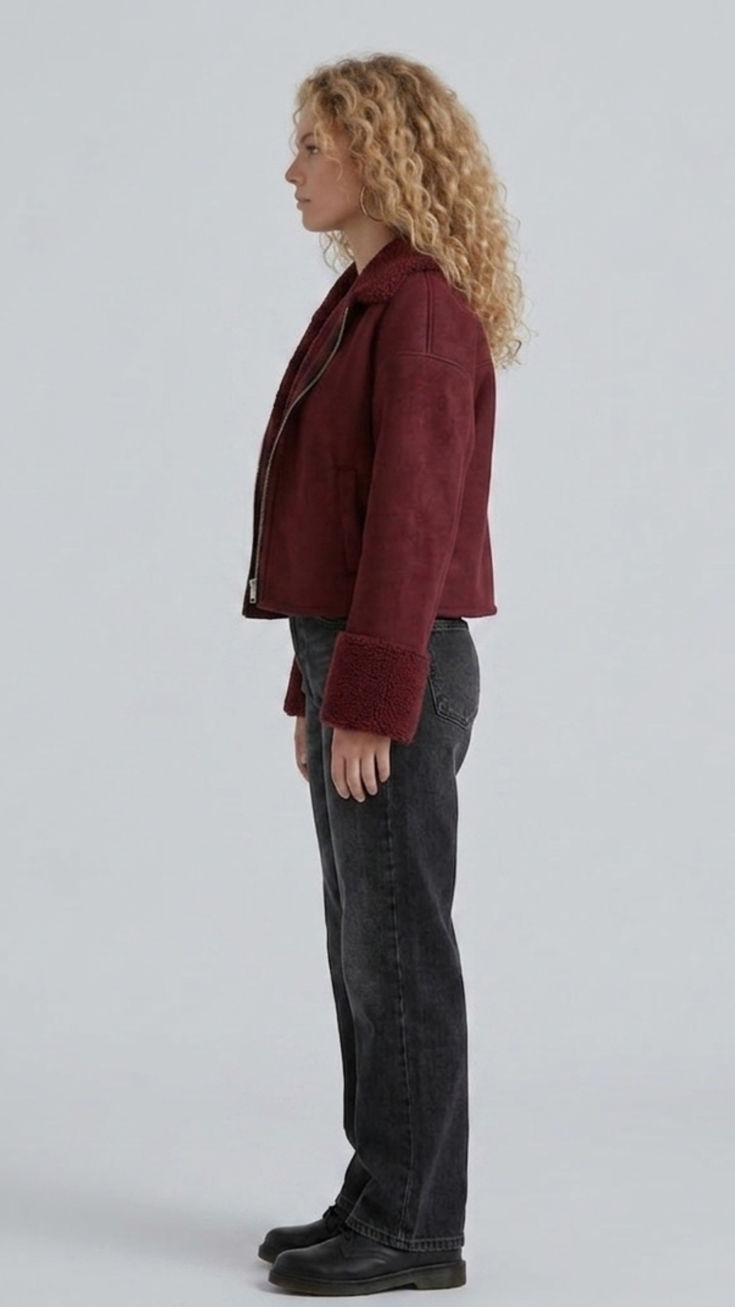 Side angle profile shot showcasing the heavy-duty metallic zippers, pockets, and adjustable waist buckles of the premium maroon suede aviator outerwear.