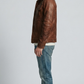 Side angle profile view focusing on the heavy-duty antiqued metallic zippers and reinforced stitch linings of the rustic brown outerwear.