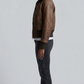 Side angle profile view detailing the durable matching dark brown elastic ribbed waistband and snug comfort cuffs of the flight outerwear.