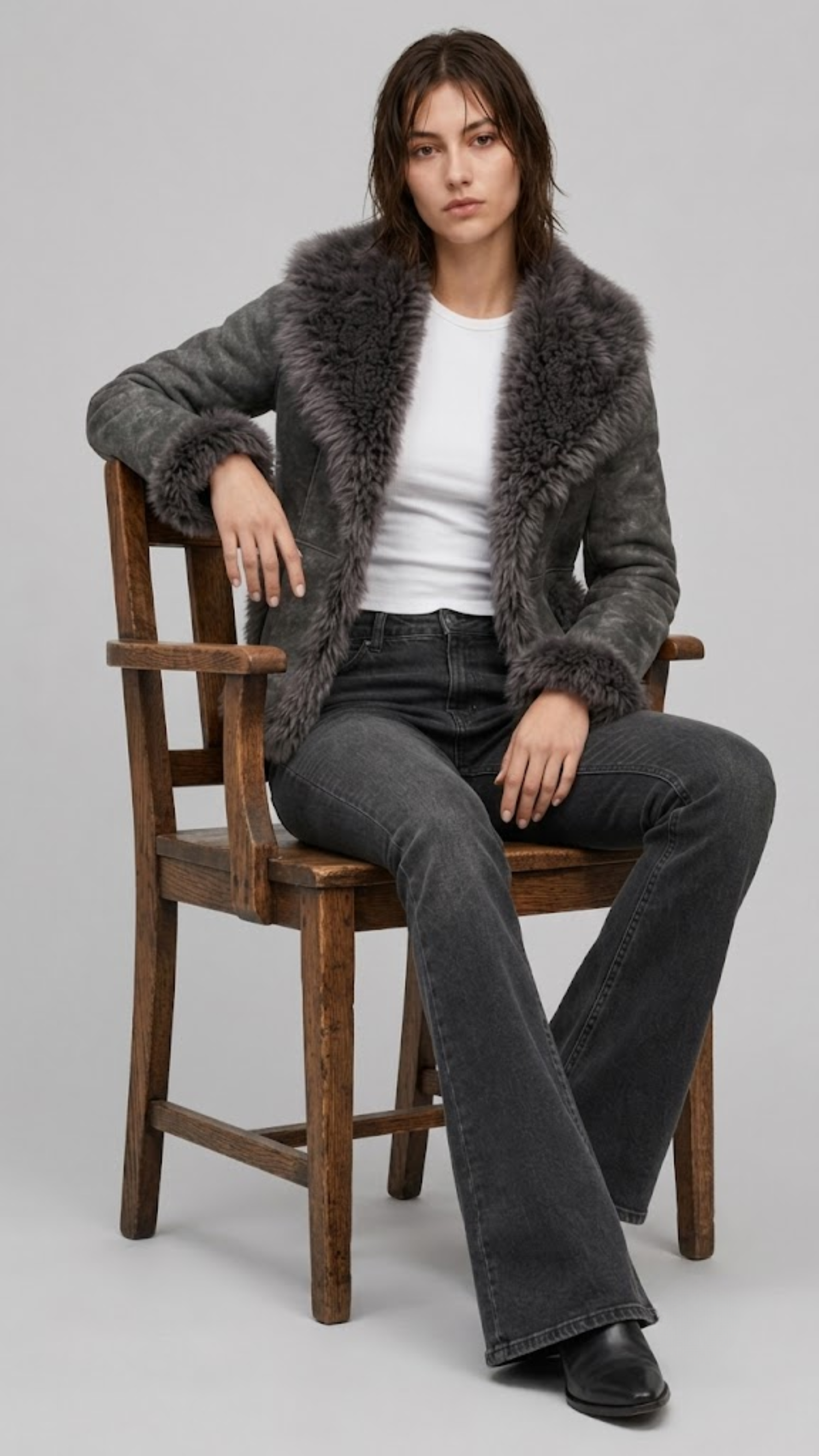 JACKERO Charcoal grey shearling coat featuring dramatic fluffy fur lapels, fur cuffs, and a plush fur hem trim.