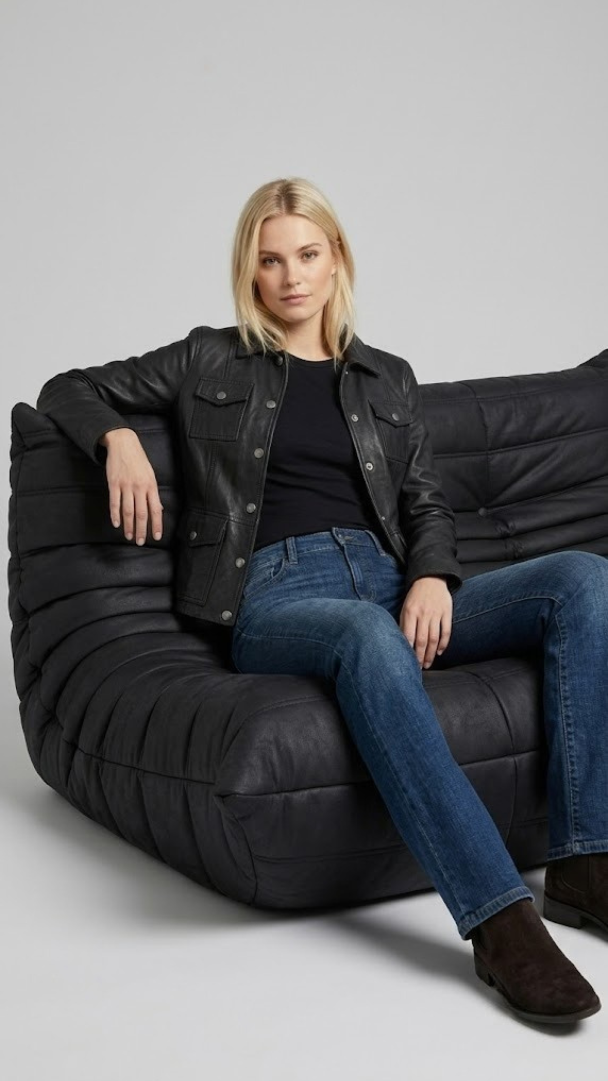 Premium women's style lookbook editorial showcasing a structured seasonal layering outfit anchored by a luxury black leather trucker coat.