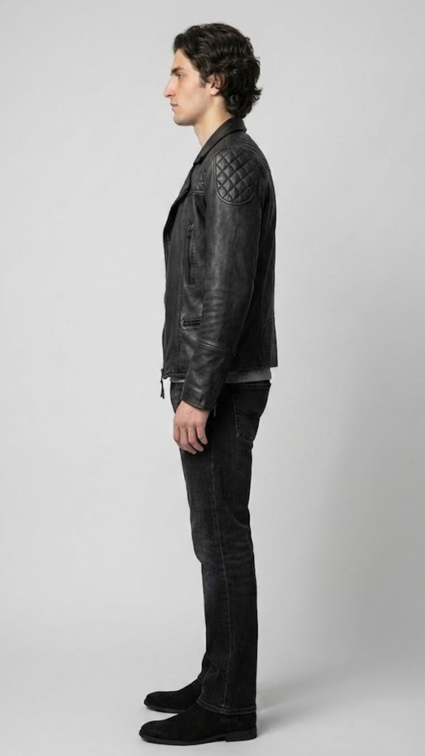 Side angle profile view highlighting the classic wide snap-down lapels and heavy industrial utility details of the premium black outerwear.