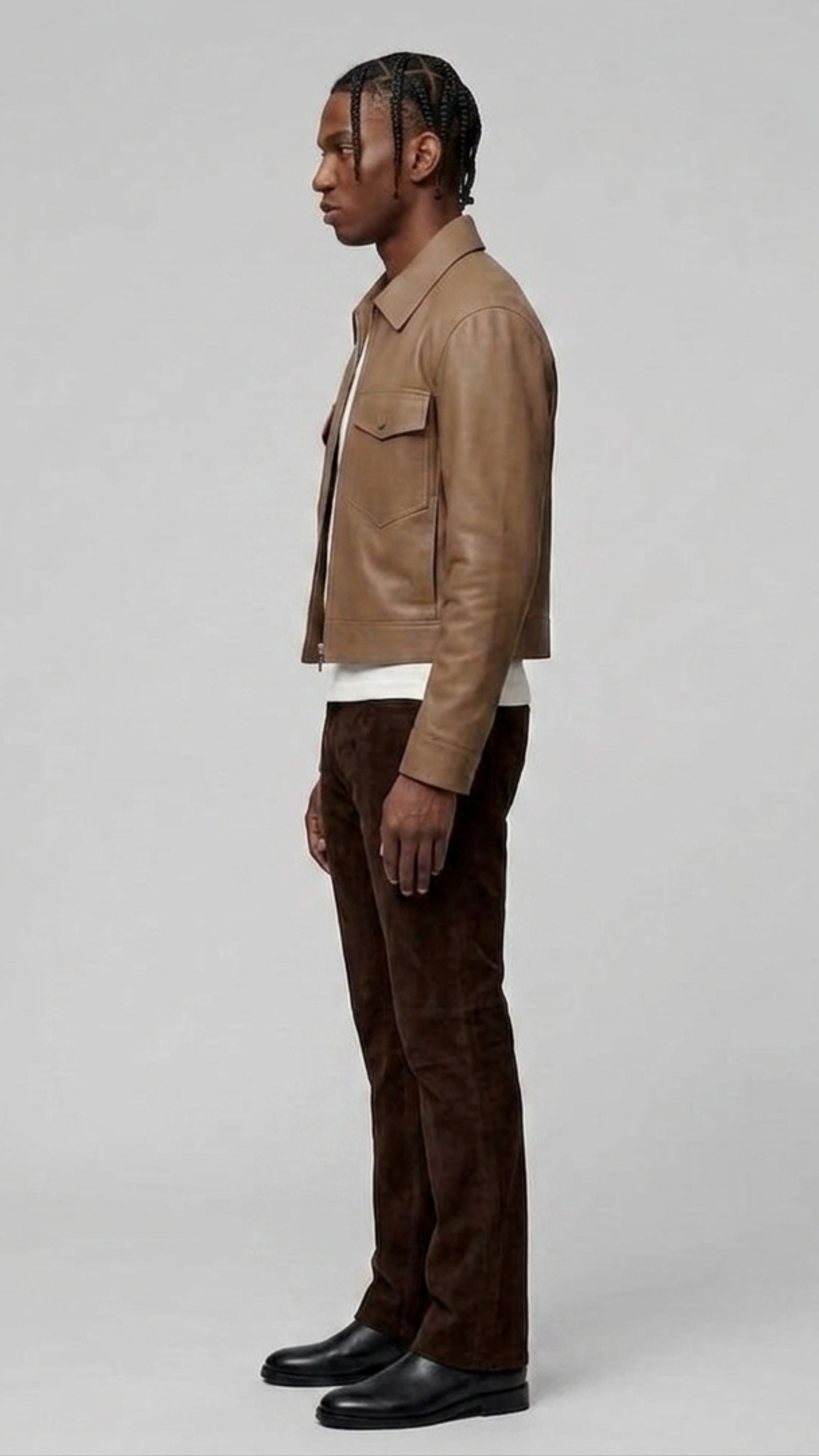 Side angle profile view focusing on the heavy-duty metallic hardware zipper and tonal elastic ribbed cuffs of the neutral beige outerwear.