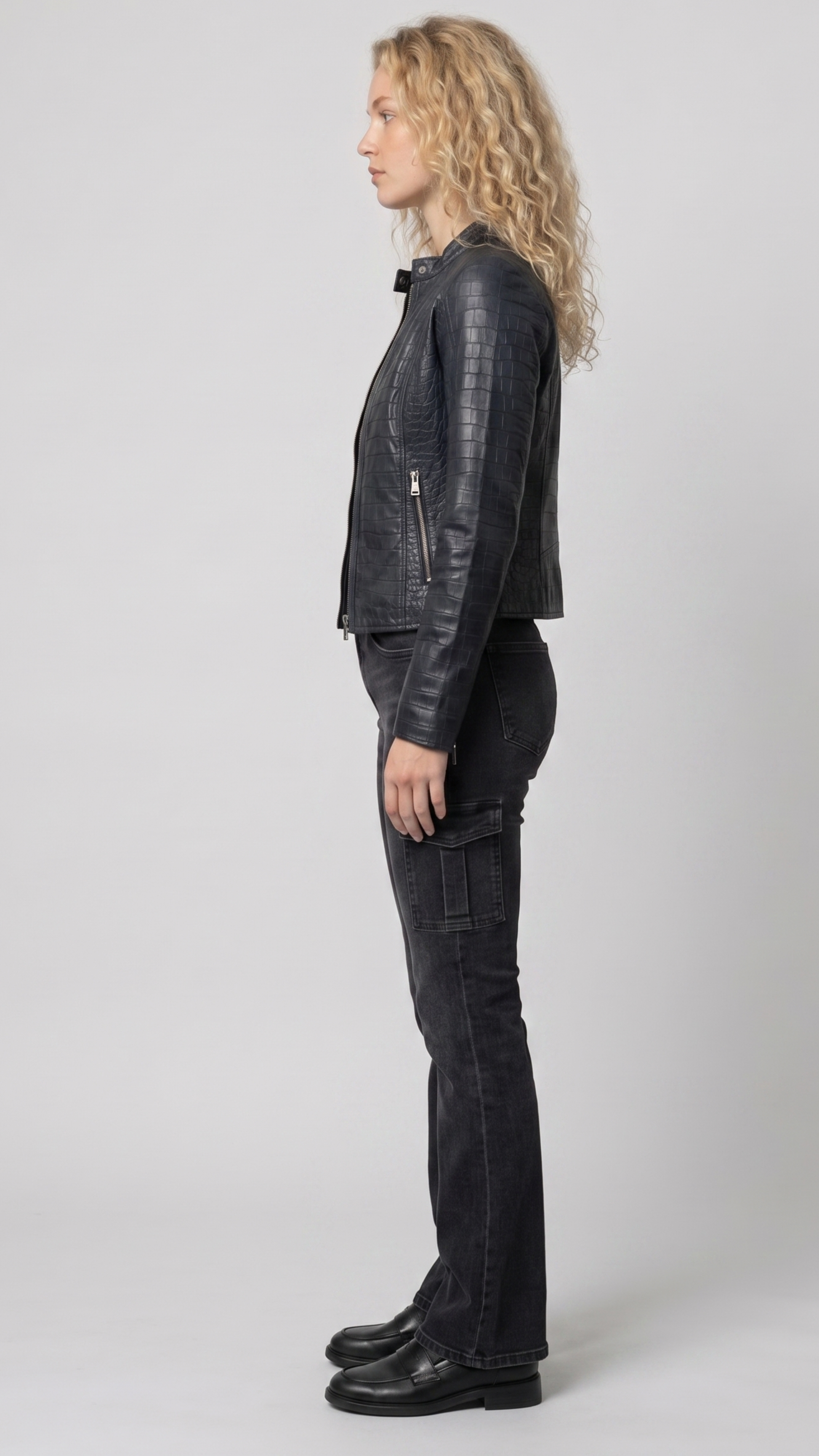 Detailed view of the structured collar lapels, metallic snap buttons, and premium stitching on a women's luxury croc-embossed jacket.