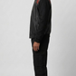 Detailed view of the athletic striped black and red rib-knit collar, cuffs, and waistband on a high-quality leather casual jacket.