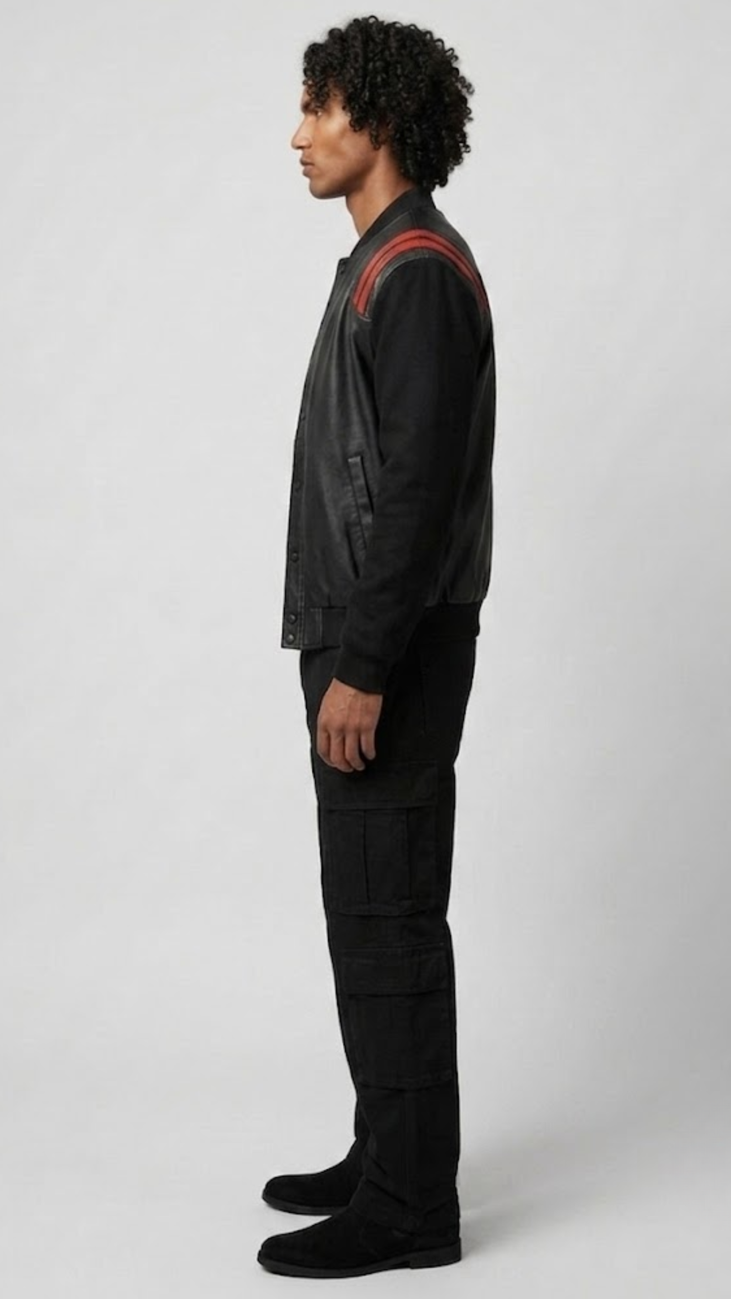 Detailed view of the athletic striped black and red rib-knit collar, cuffs, and waistband on a high-quality leather casual jacket.