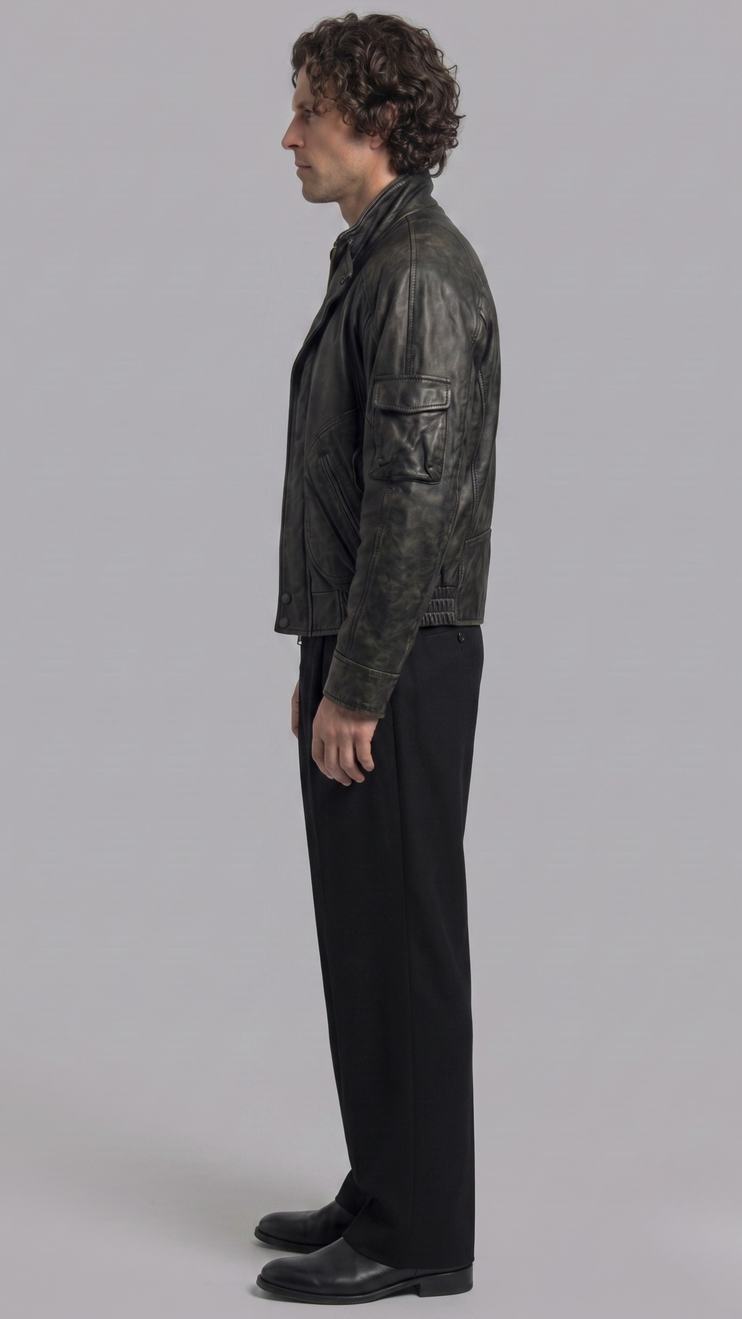 Versatile faded black leather jacket layered effortlessly over a casual white tee for a classic urban streetwear aesthetic.