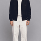 Full front view of model wearing a dark navy blue cotton jacket with a sleek front zipper and stand collar
