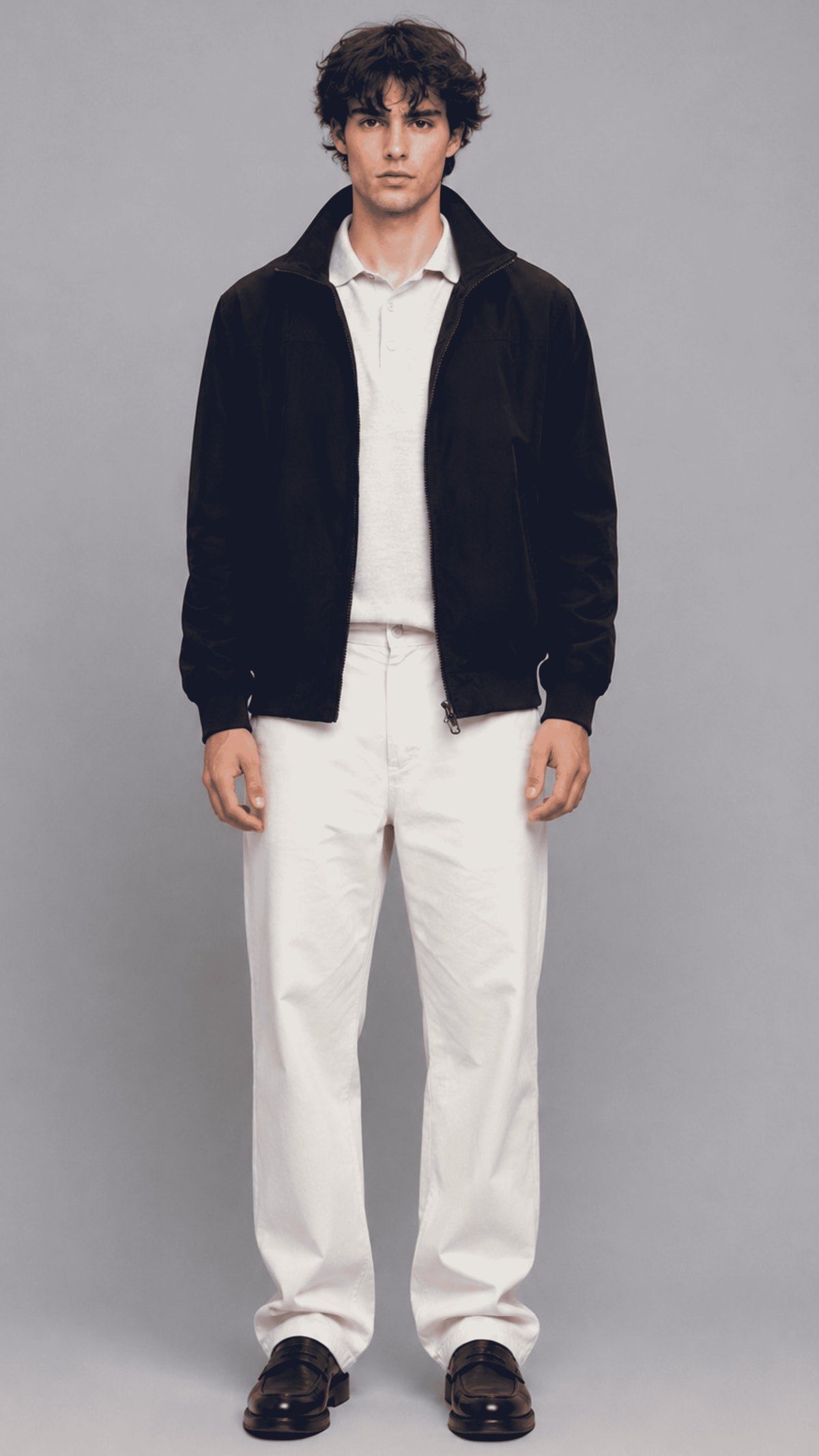 Full front view of model wearing a dark navy blue cotton jacket with a sleek front zipper and stand collar
