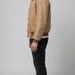 Minimalist tan cotton jacket perfectly layered over a basic white t-shirt for an effortless daily streetwear outfit.