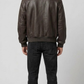 Men's luxury fashion featuring a unique two-tone dark brown and black croc skin textured leather jacket.