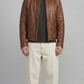 Front perspective of a premium brown leather jacket by Jackero, displaying a warm chocolate shade, clean zipper closure, and classic pocket placement.