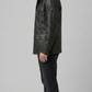Versatile black leather field jacket layered over an urban outfit, perfect for combining practical utility with modern street fashion.