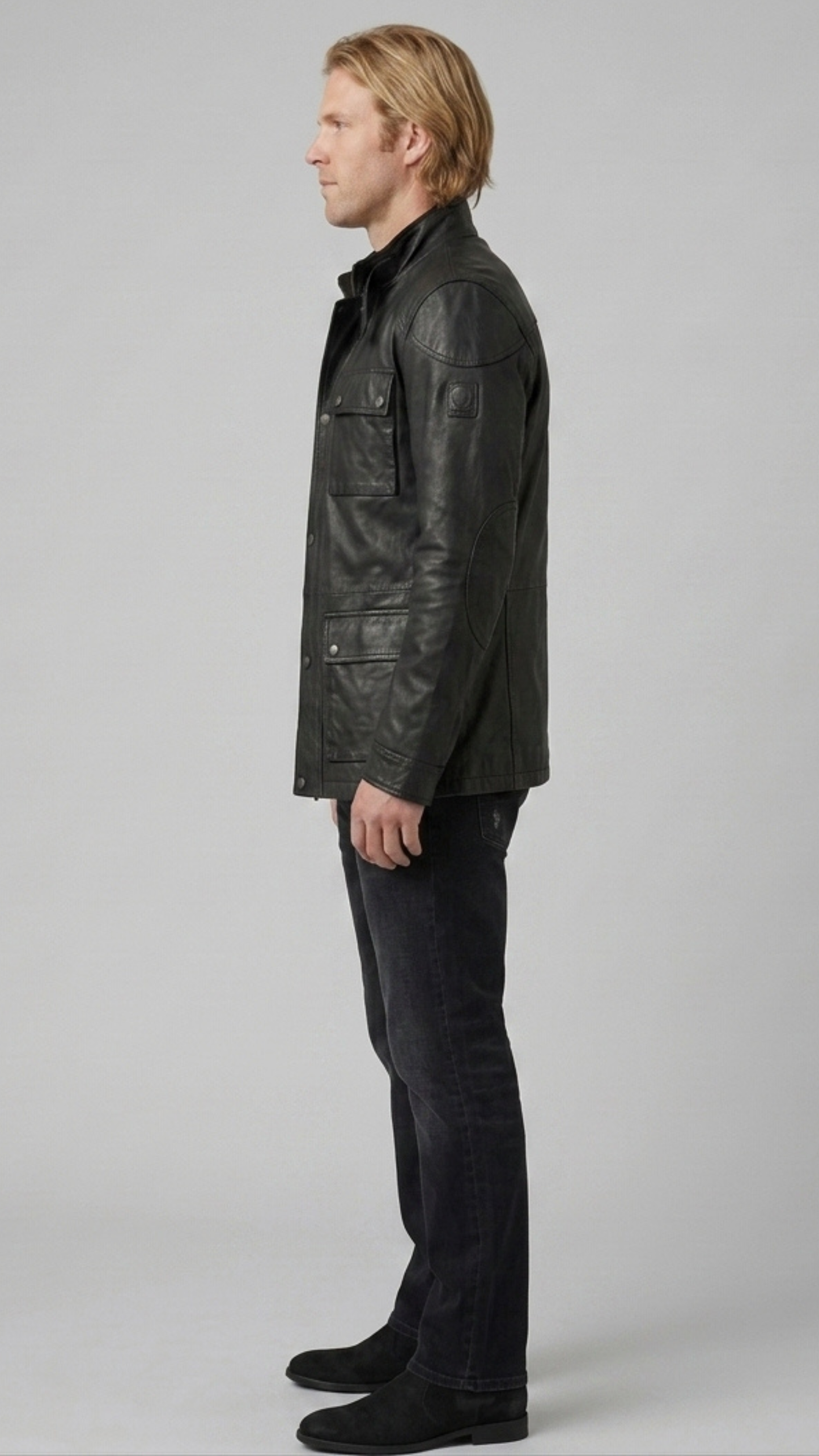 Versatile black leather field jacket layered over an urban outfit, perfect for combining practical utility with modern street fashion.