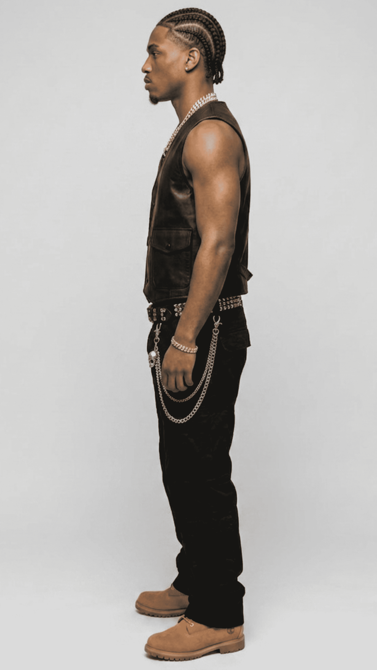 Versatile black leather button up vest layered elegantly over a white dress shirt, perfect for a high-end modern aesthetic.