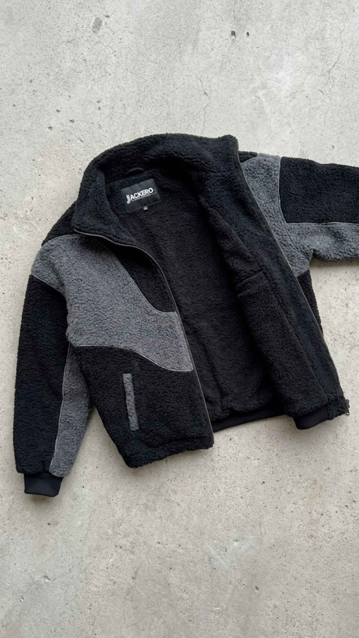Detailed view of soft-touch interior lining and plush textured colorblocked wool fleece material.