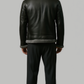 back view of a high-quality black leather winter coat showing precise panels, stitching, and the contrast grey fur collar.