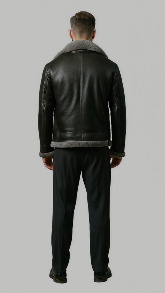 back view of a high-quality black leather winter coat showing precise panels, stitching, and the contrast grey fur collar.