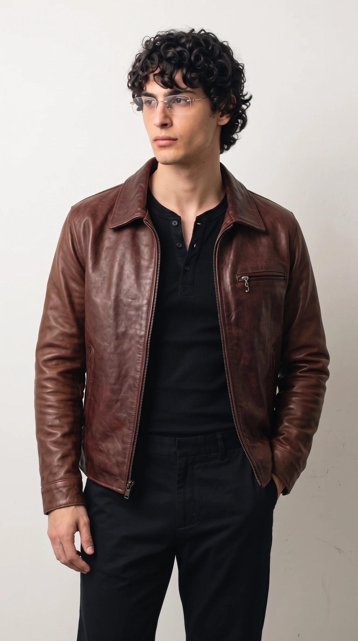 A men’s burgundy leather jackero jacket with a clean fold-down collar and silver front zipper, a minimalist classic wine red jacket that suits smart casual outfits
