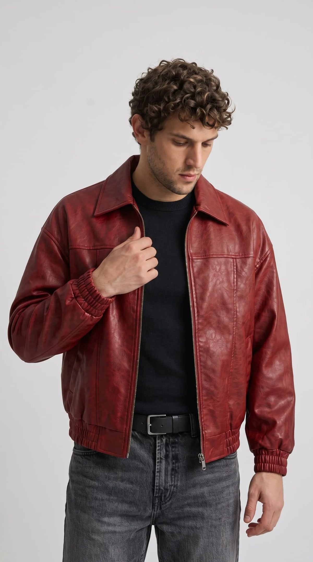 Vibrant red leather bomber jacket shown from the front view in a clean studio setting.