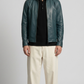 Jackero premium dark cyan leather jacket styled with crisp high-fashion urban streetwear.