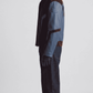 Side view showing waist slash pockets and dark blue leather cuff details on dual-texture streetwear jacket.