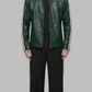 A male model wearing a dark green leather jacket with white stripe details on the sleeves, styled with a black shirt, black trousers, and black shoes, set against a solid gray background.