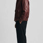 High-resolution detail of rich dark red leather grain finish and durable structural seam stitching.