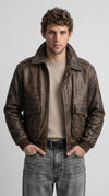 Men's distressed brown genuine leather bomber jacket with vintage worn finish, spread collar, full zip front closure, flap chest pockets and ribbed knit cuffs, classic aviator style outerwear for men