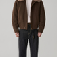 Premium dark brown leather jacket featuring a plush off-white shearling collar, dual chest pockets, and front button-up closure by Jackero.