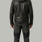 Rear view of a fitted black leather hooded jacket showcasing the tailored waist paneling and seamless shoulder construction.