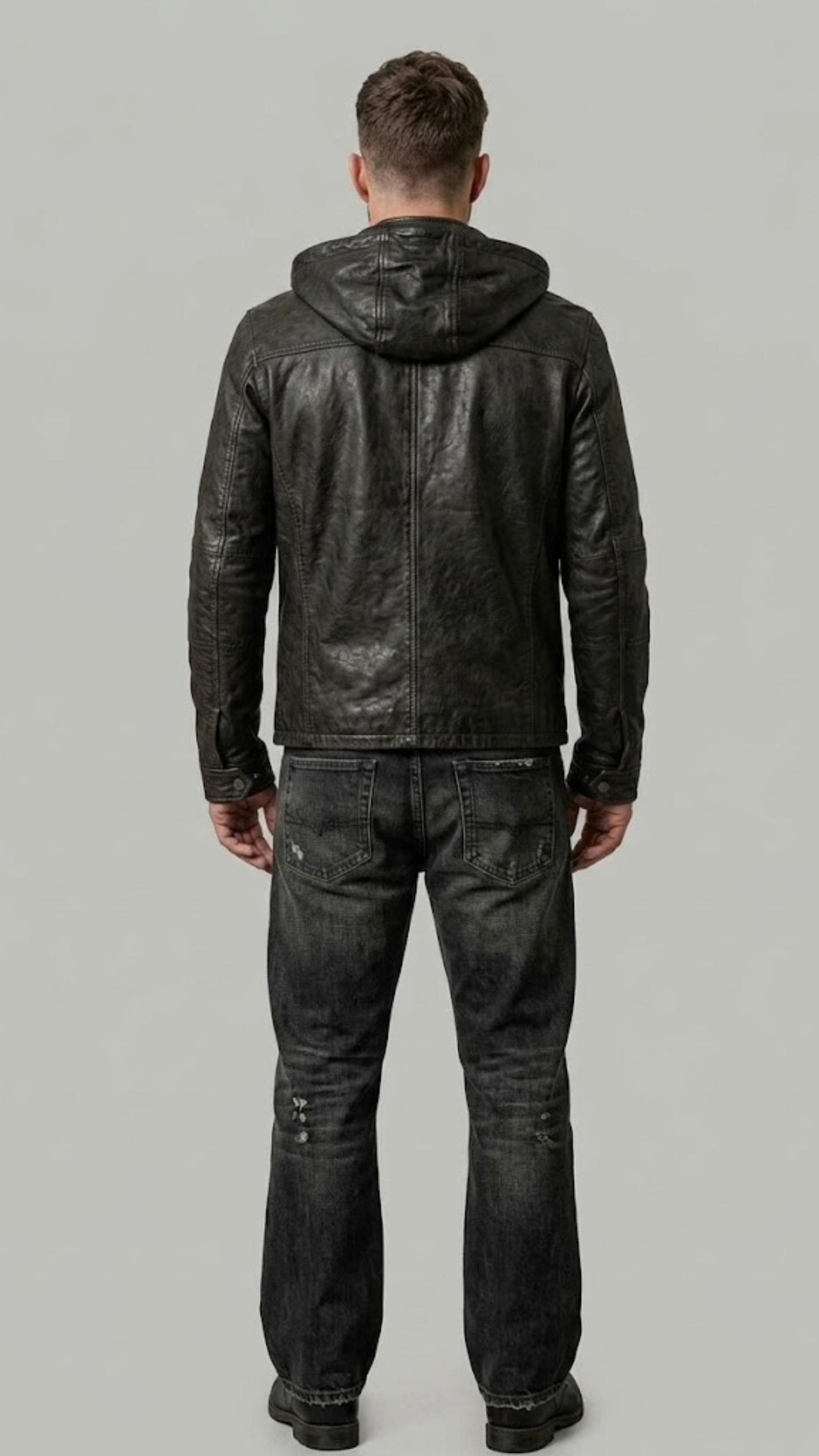 Rear view of a fitted black leather hooded jacket showcasing the tailored waist paneling and seamless shoulder construction.