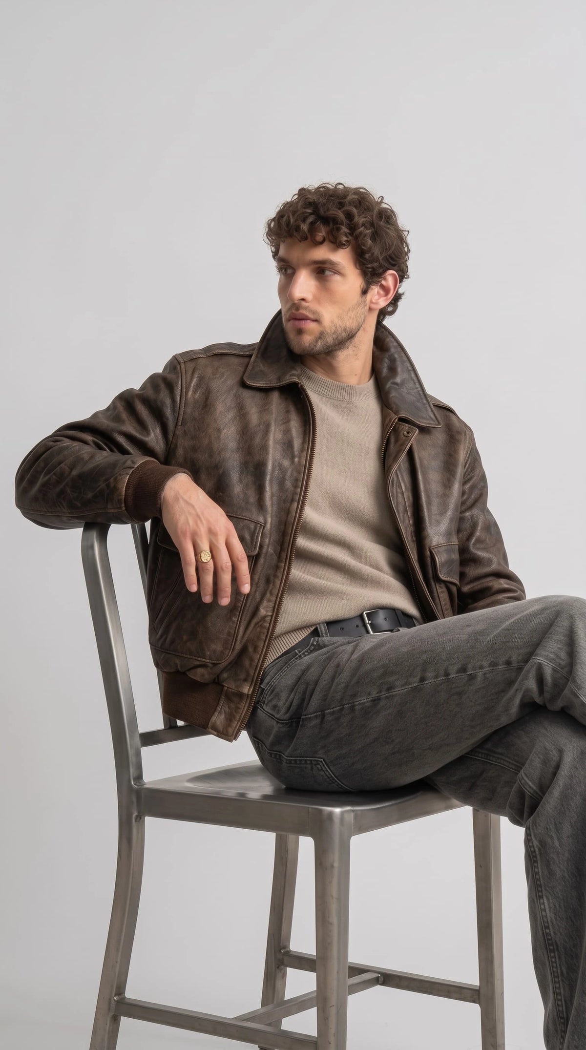 Men's A2 style distressed leather jacket in rich espresso brown, collared neckline with snap tab, zip closure, double chest flap pockets and elastic rib trim, heritage military inspired design