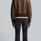 Symmetrical back view photo showcasing the clean structured back panel layout and robust shoulder seams of the chocolate brown leather jacket.
