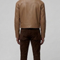 Symmetrical rear view of the light sand leather bomber jacket highlighting the seamless shoulder yoke and premium clean stitched panels.