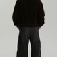 high-quality dark brown suede winter coat showing the rich matte leather finish and clean structural seams.