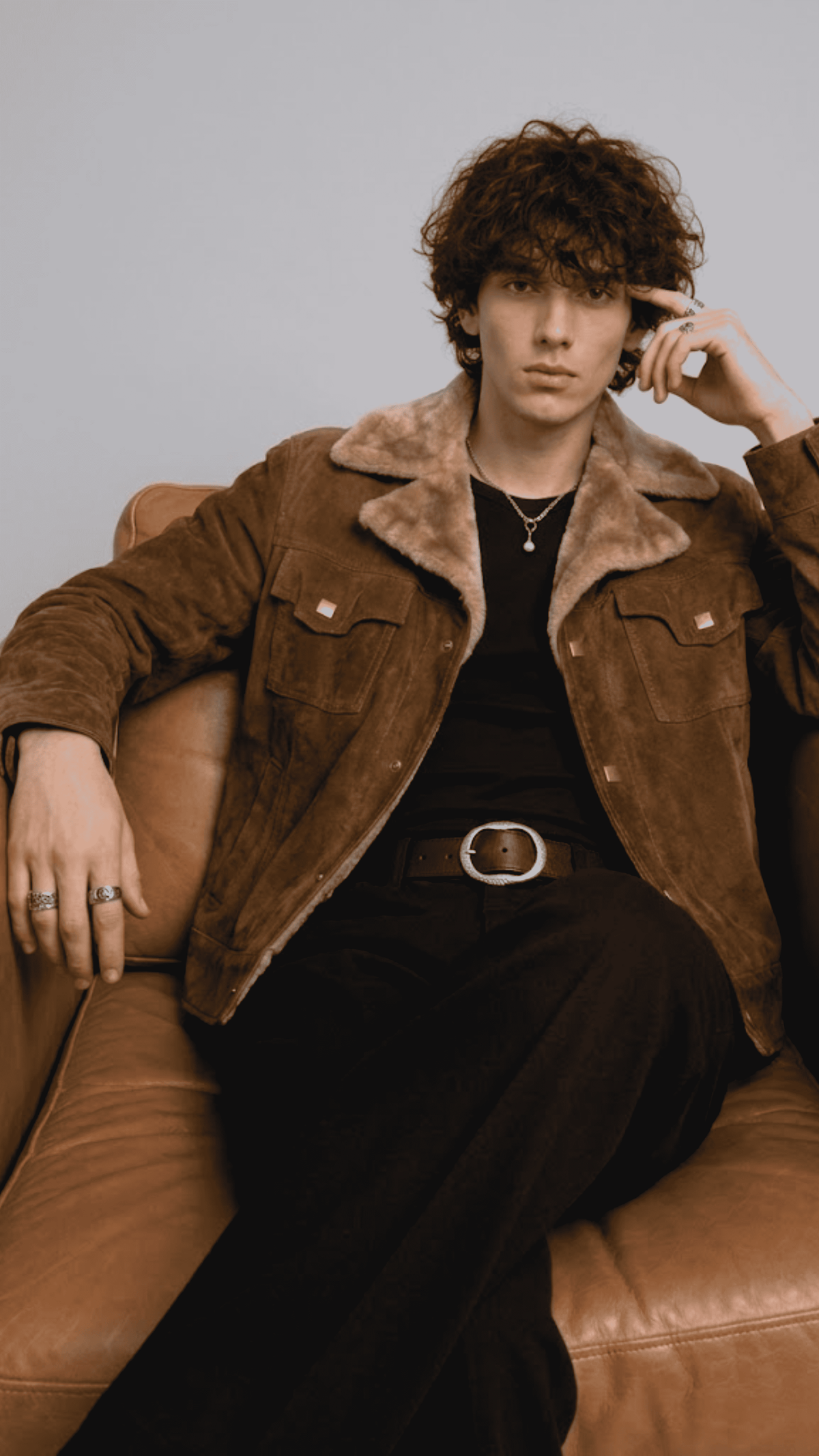 the structured fur collar, durable metallic front zip, and deep welt side pockets on a mustard suede coat.