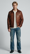Front view lookbook photography of a model showcasing the Jackero premium dark tan brown distressed leather jacket styled with modern rugged streetwear.