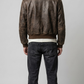 Symmetrical rear view studio shot highlighting the uniform weathered texture and rich coffee brown panels of the retro leather flight coat.