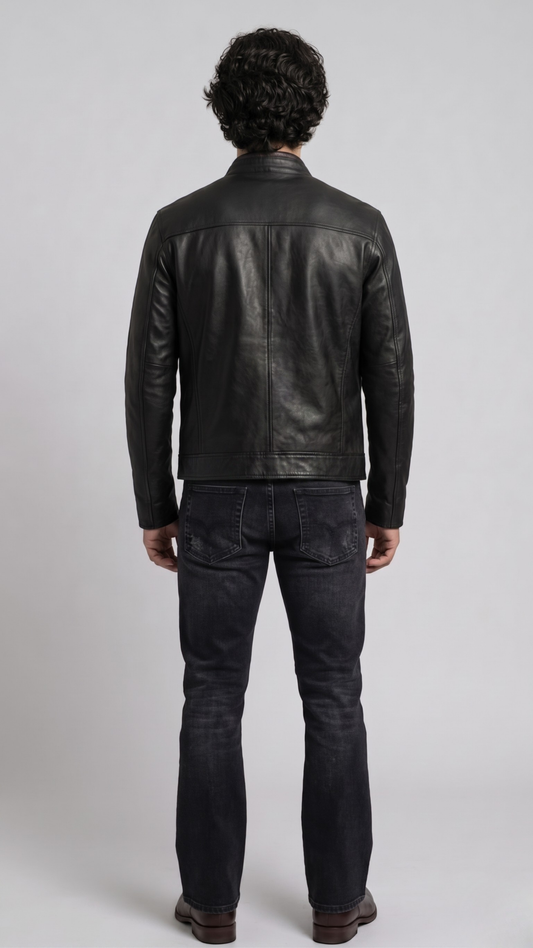 Straight-on back view of a structured black leather motorcycle jacket highlighting its tailored panelling and clean shoulder lines.