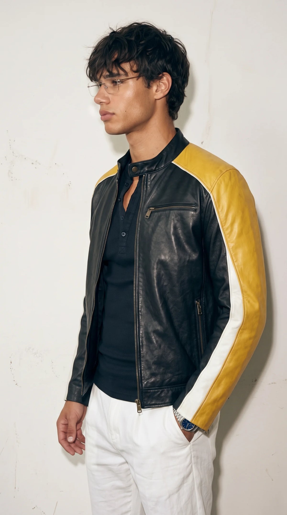 Men’s tricolour motorcycle leather jacket combining a matte-black body with mustard-yellow shoulders and white sleeve accents, worn over a dark shirt for a sharp, streamlined outfit. Its stand-up snap collar, full-length front zipper and close-fitting profile create an athletic cafe racer aesthetic that works for modern city wear, weekend outings and statement casual dressing.