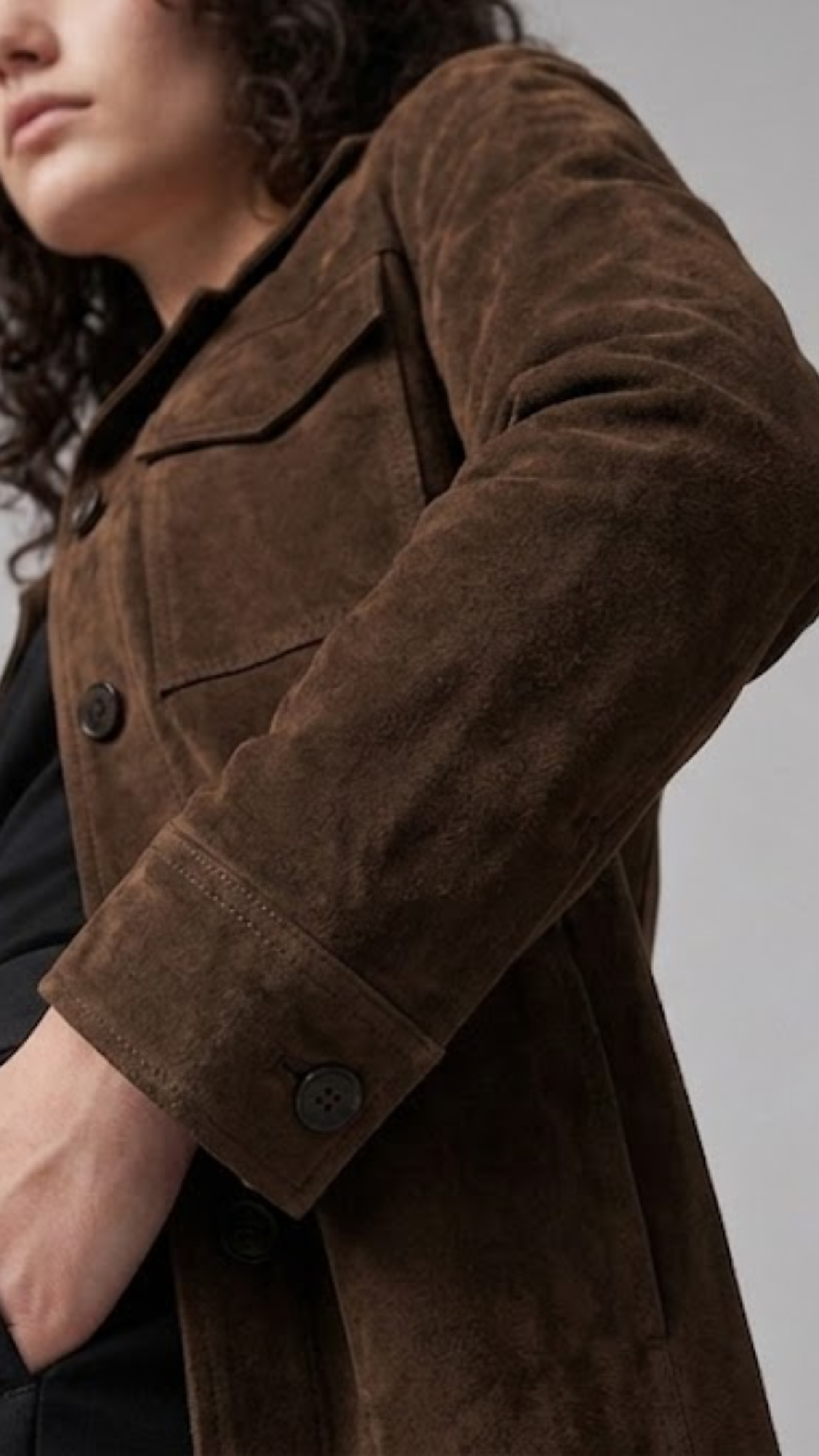 Relaxed mid-length women's suede coat with clean seam detailing and button closure.