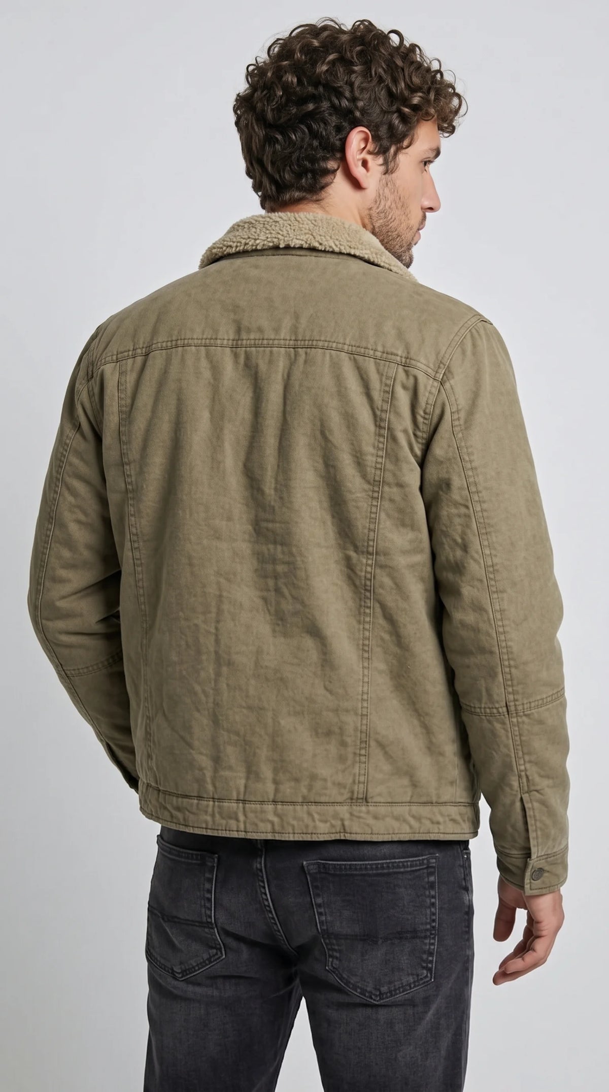 Military-olive cotton field jacket with a beige shearling-style collar, horizontal shoulder yoke, carefully stitched vertical back panels and a straight structured hem, showcasing its rugged workwear construction and classic utility-inspired silhouette for cool-weather outfits.