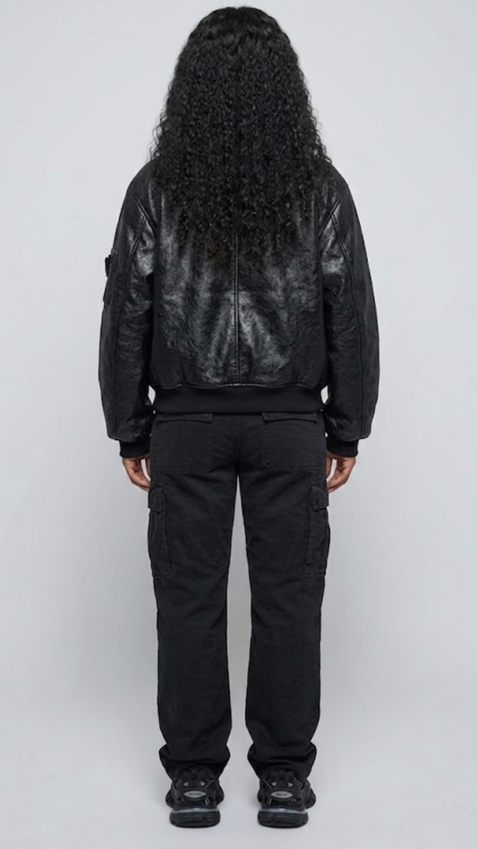Clean back angle of a structured black leather bomber coat, highlighting the relaxed fit shoulders and tapered ribbed waist bottom alignment.