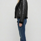Model wearing a stylish black leather aviator jacket with a warm fur collar for a rugged winter streetwear look.