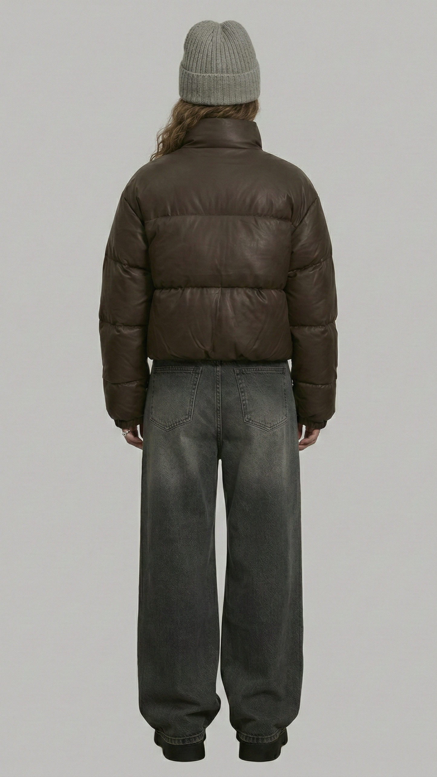 a high-quality chocolate brown winter coat highlighting the insulated puffer design and robust stitching details.